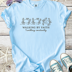 Light blue t-shirt with crab design and text 'Walking by Faith, Tumbling constantly', made from soft cotton.