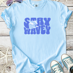 Light blue cotton t-shirt with 'Stay Wavey' graphic and wave design, perfect for beachwear.