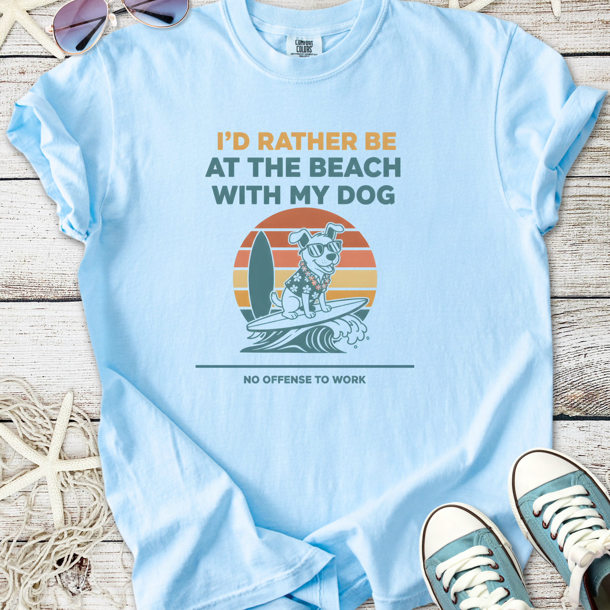 Light blue t-shirt featuring a dog on a surfboard with beach-themed text, perfect for dog lovers.