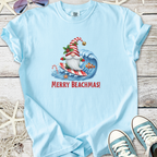 Light blue t-shirt featuring a surfing Santa with 'Merry Beachmas!' slogan, perfect for festive beach outings.