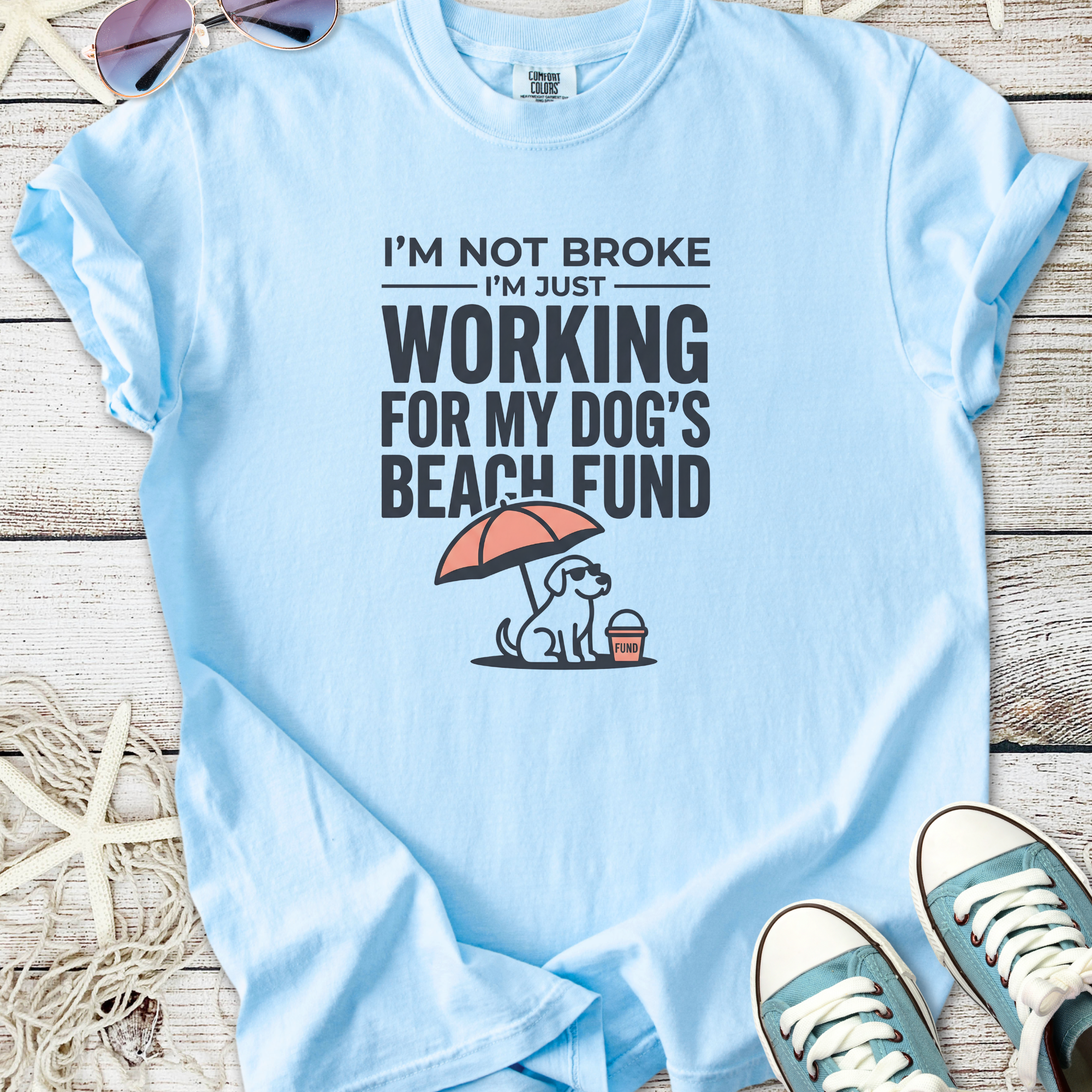 Light blue t-shirt with funny 'Dog's Beach Fund' graphic, made from soft cotton, perfect for dog lovers.