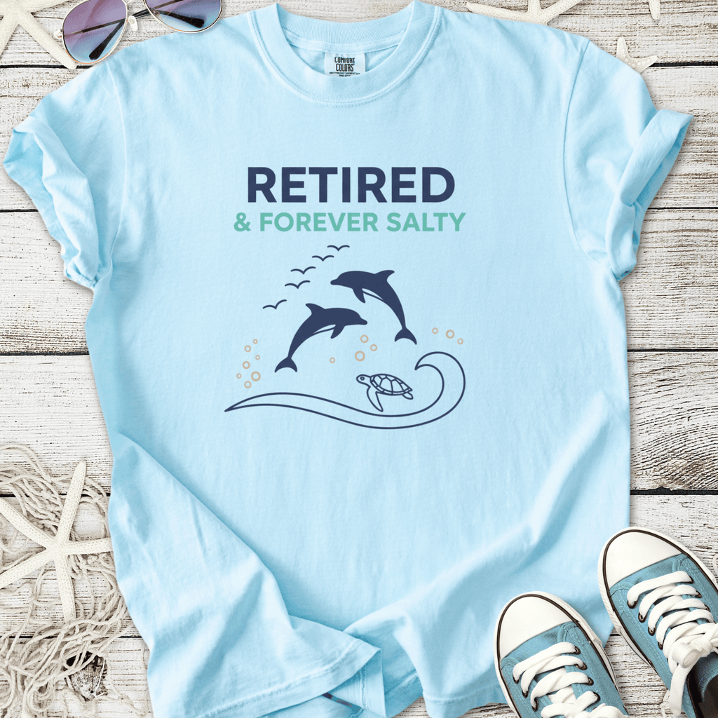 Light blue t-shirt with 'Retired & Forever Salty' print, featuring dolphins and a turtle design.