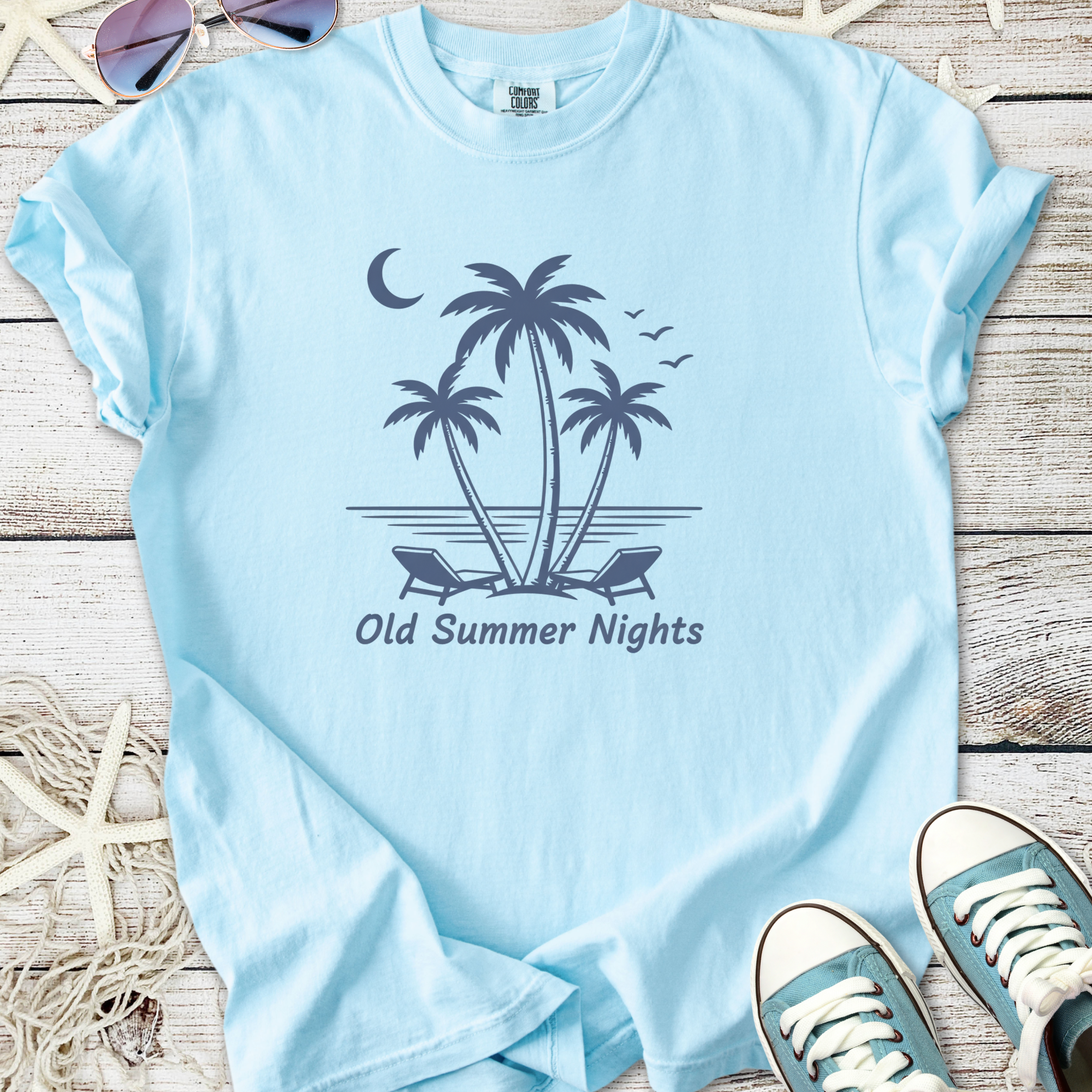 Light blue t-shirt featuring 'Old Summer Nights' palm tree graphic, casual style, perfect for summer vibes.
