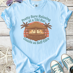 Light blue t-shirt featuring 'Pretty Sure Relaxing at a Tiki Bar' graphic with tropical design.