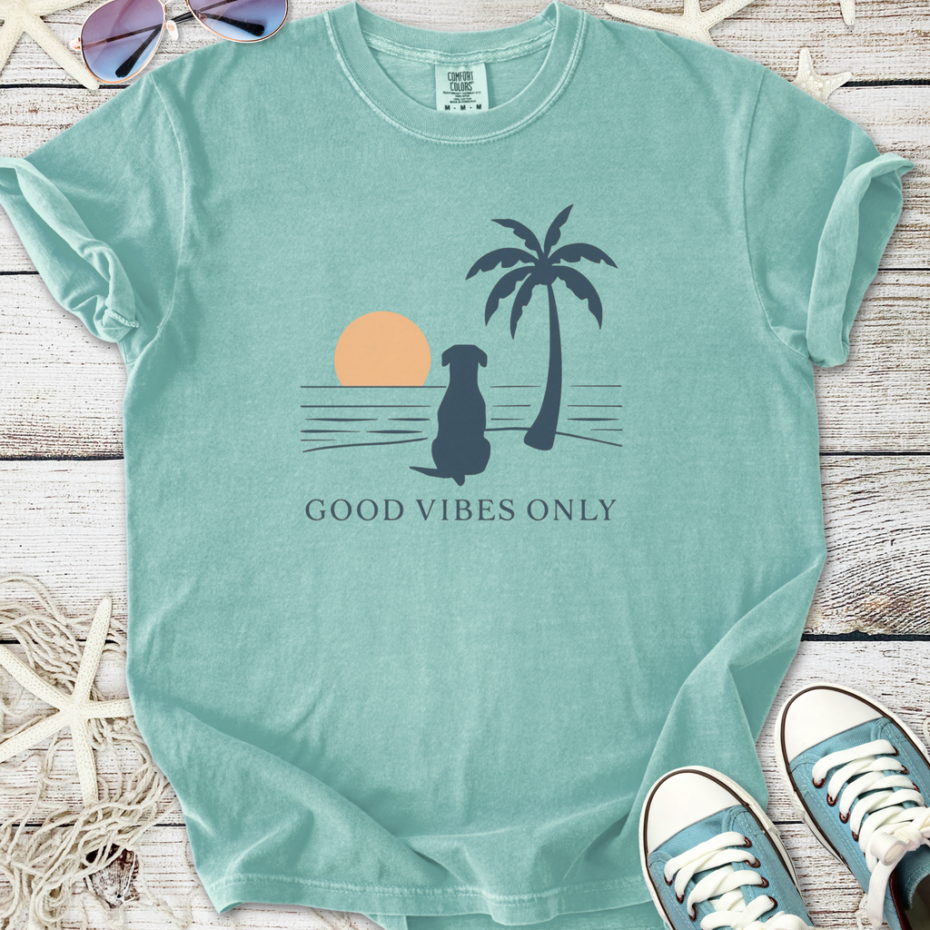 Mint green 'Good Vibes Only' t-shirt with dog, palm tree, and sunset graphic design.