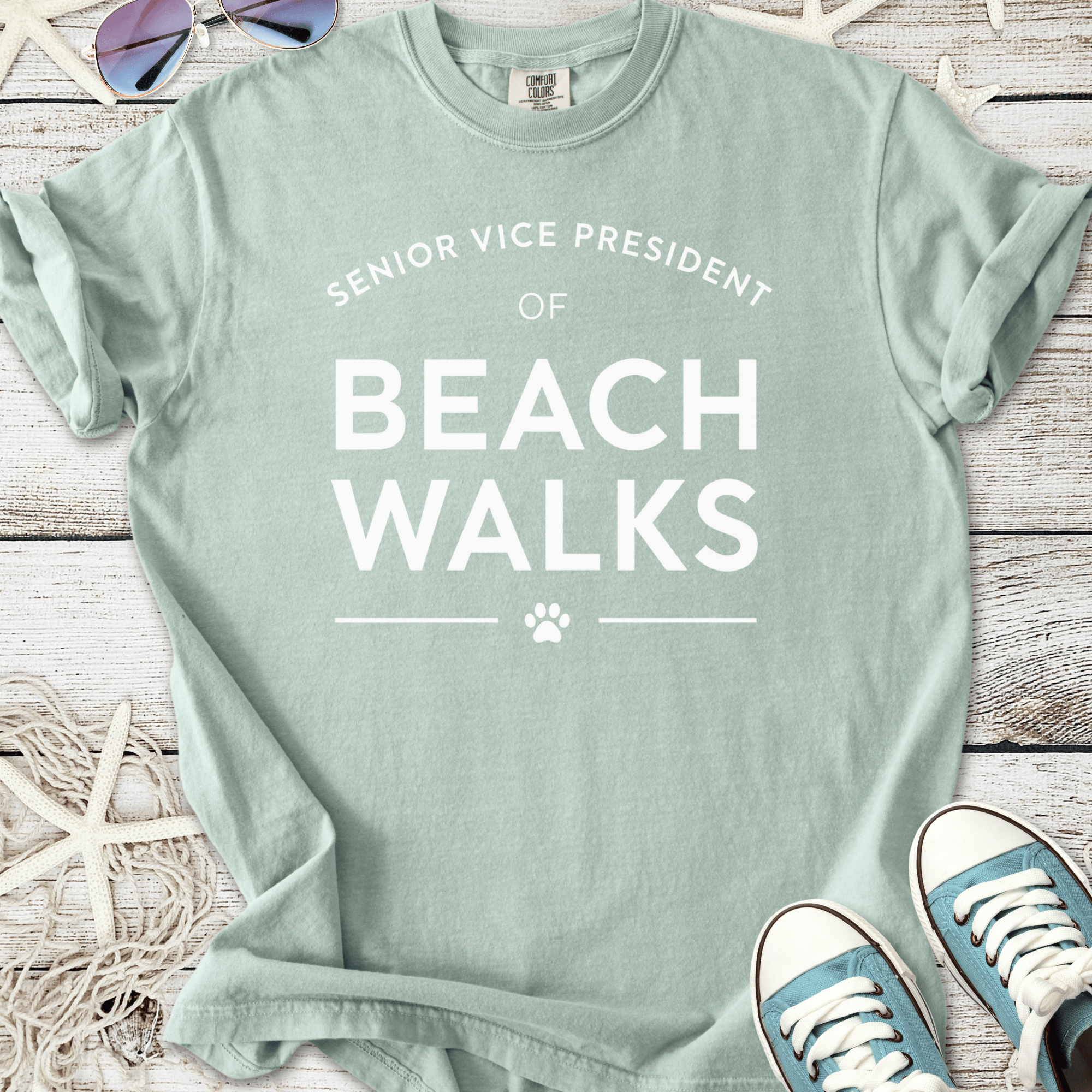 Mint green t-shirt with 'Senior Vice President of Beach Walks' print, perfect for casual summer outings.