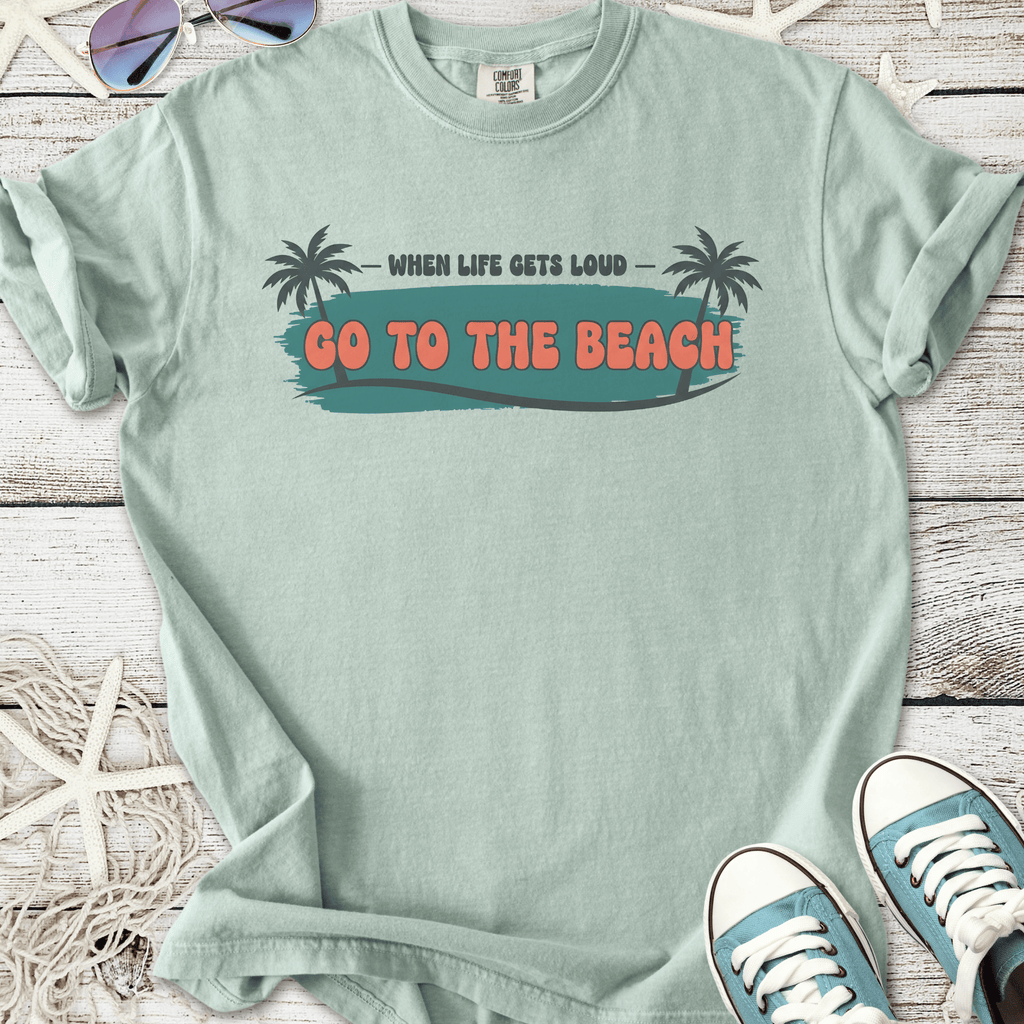 Mint green graphic t-shirt with 'Go to the Beach' slogan and palm tree illustrations.