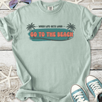 Mint green graphic t-shirt with 'Go to the Beach' slogan and palm tree illustrations.