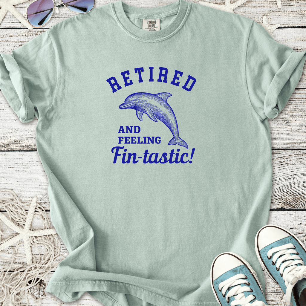 Light blue cotton t-shirt with dolphin graphic and 'Retired and Feeling Fin-tastic!' slogan.