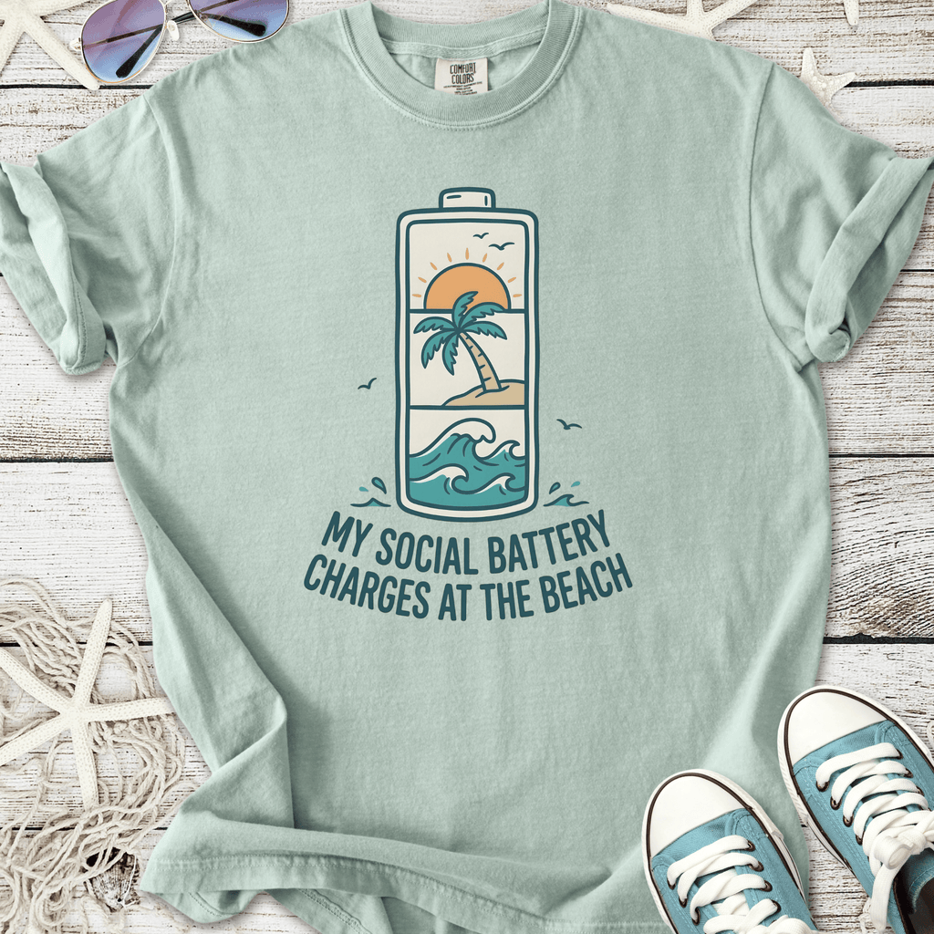 Mint green t-shirt with beach-themed graphic saying 'My Social Battery Charges at the Beach'.