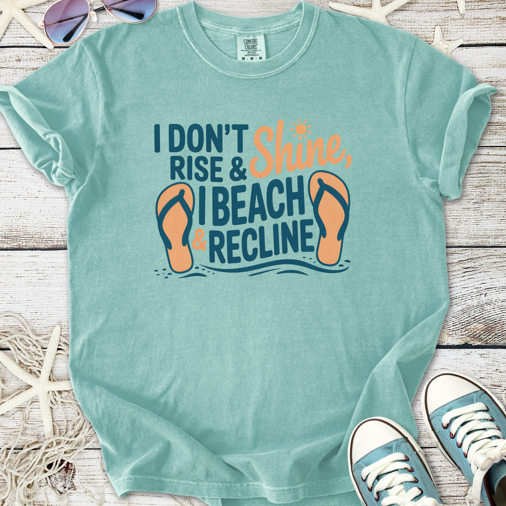 Mint green graphic tee with 'I Don't Rise & Shine, I Beach & Recline' print and flip-flop design.