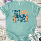 Mint green graphic tee with 'I Don't Rise & Shine, I Beach & Recline' print and flip-flop design.