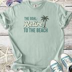 Mint green t-shirt with 'The Goal: Retire to the Beach' graphic, perfect for casual beach lovers.