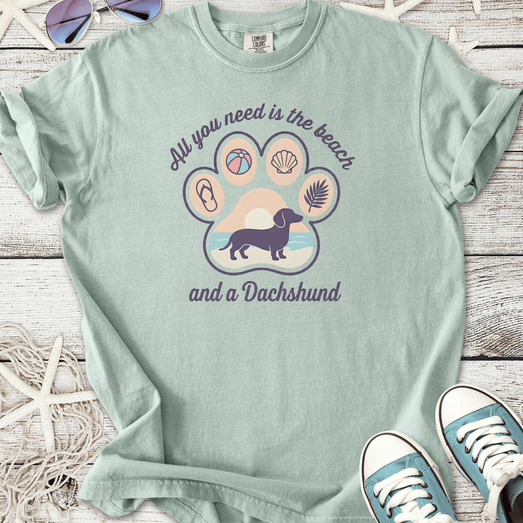 Mint green t-shirt featuring a dachshund graphic and beach-themed design, perfect for dog lovers.