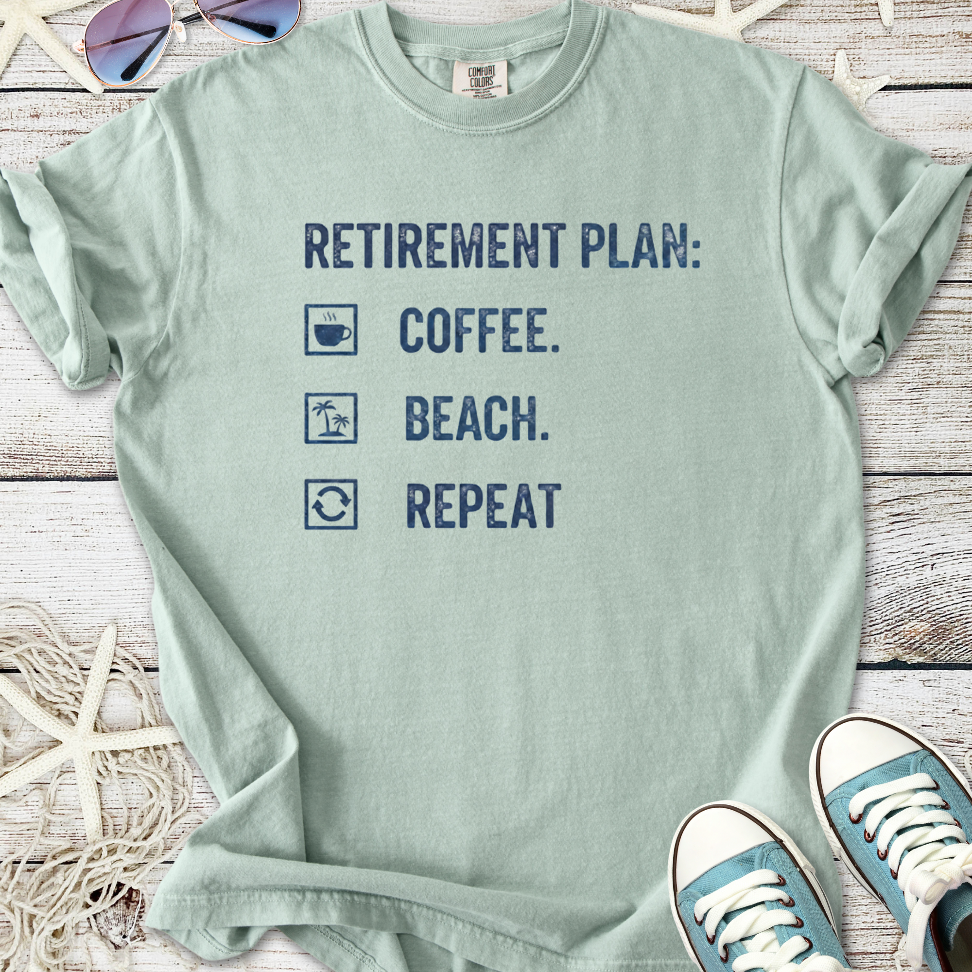 Light green retirement plan t-shirt featuring coffee, beach, and repeat graphics. Perfect casual wear.