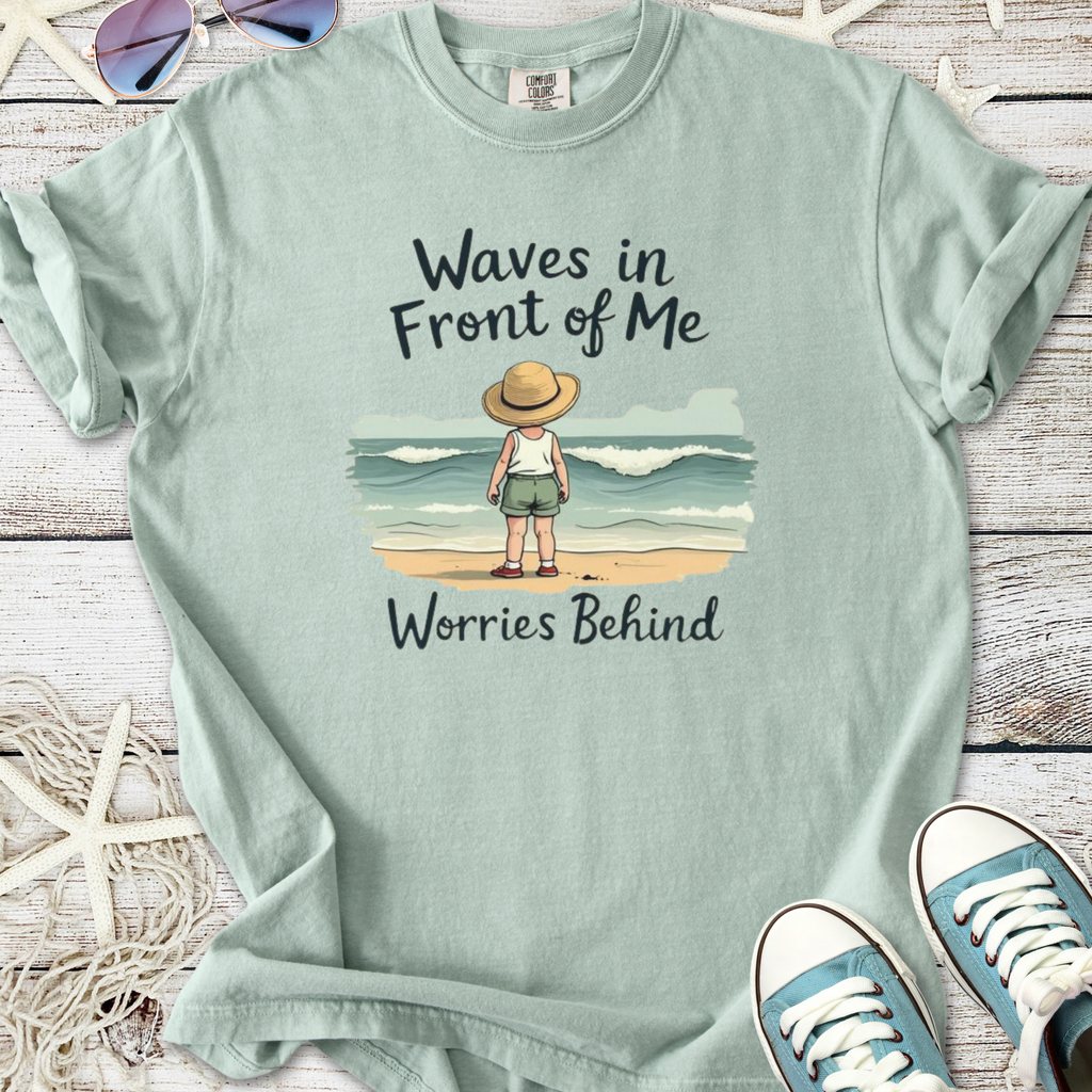 Light green t-shirt with 'Waves in Front of Me' print, featuring a child by the ocean.