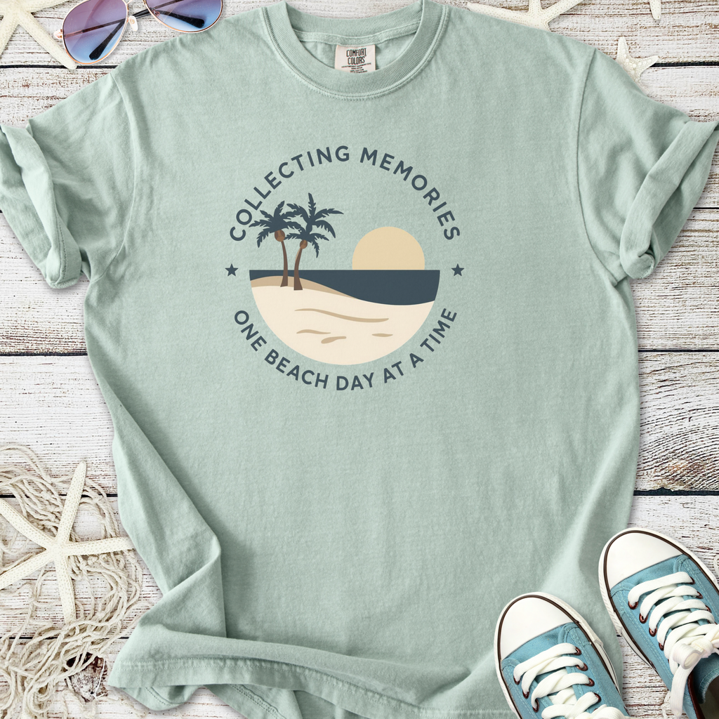 Light green graphic tee with beach-themed design featuring palm trees and sun.