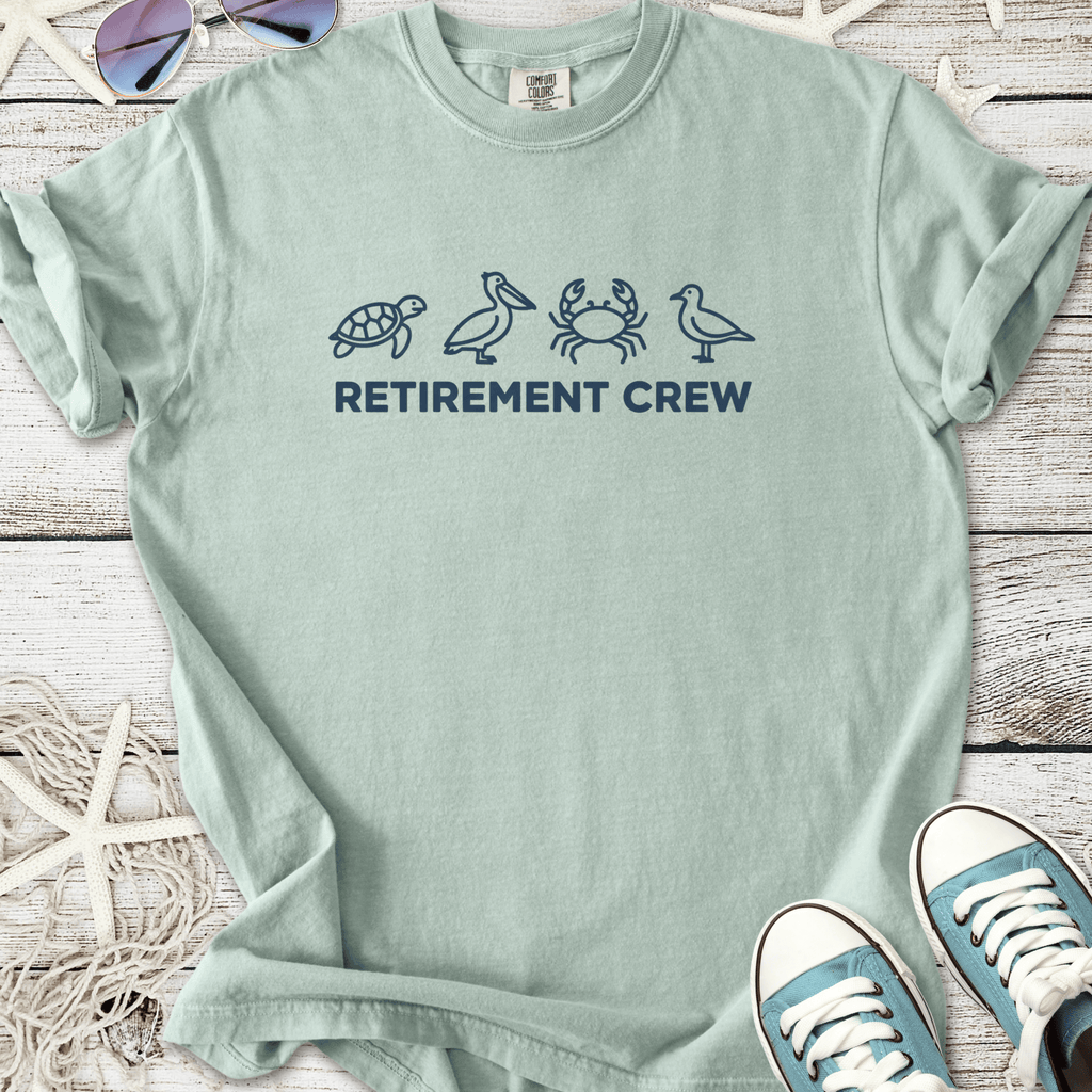 Light green retirement crew t-shirt featuring marine life graphics: turtle, pelican, crab, and bird.