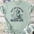 Light green beach-themed t-shirt featuring dog and surfboard graphic, perfect for pet lovers.