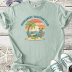 Light blue t-shirt featuring 'Permanent Vacation Club' graphic with a cartoon coconut drink and palm trees.