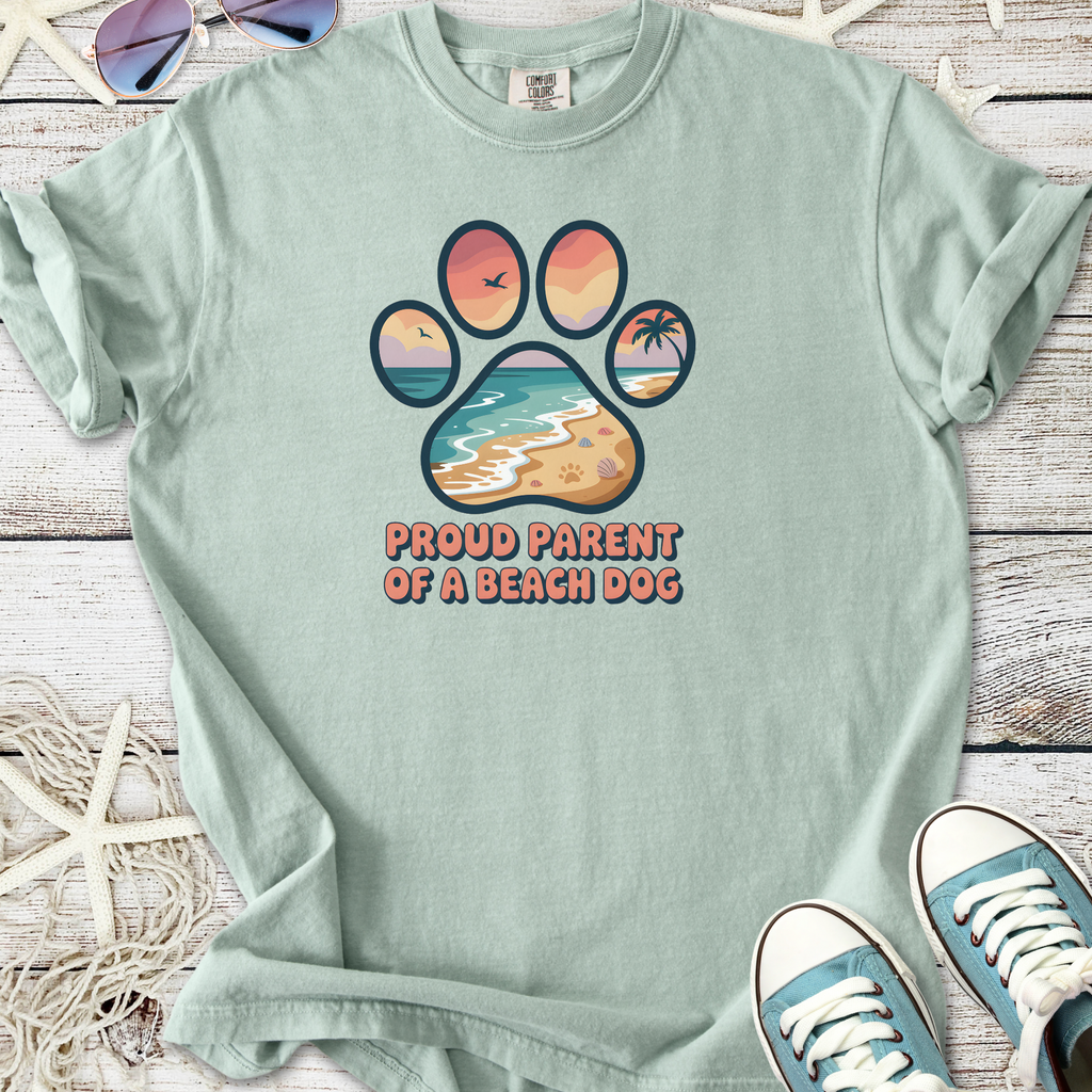 Light green t-shirt with 'Proud Parent of a Beach Dog' graphic featuring a paw print and beach scenery.