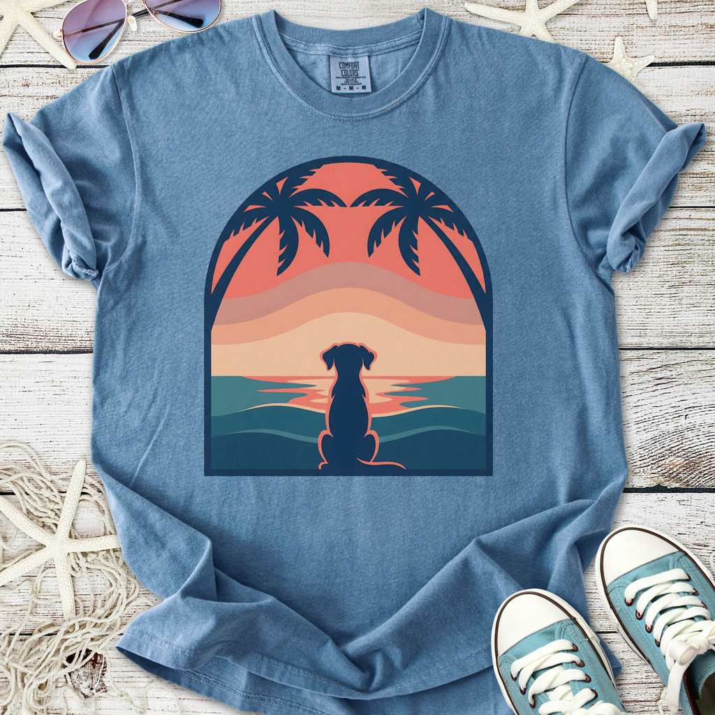 Blue graphic t-shirt featuring a dog silhouette and sunset design with palm trees, made of soft cotton.