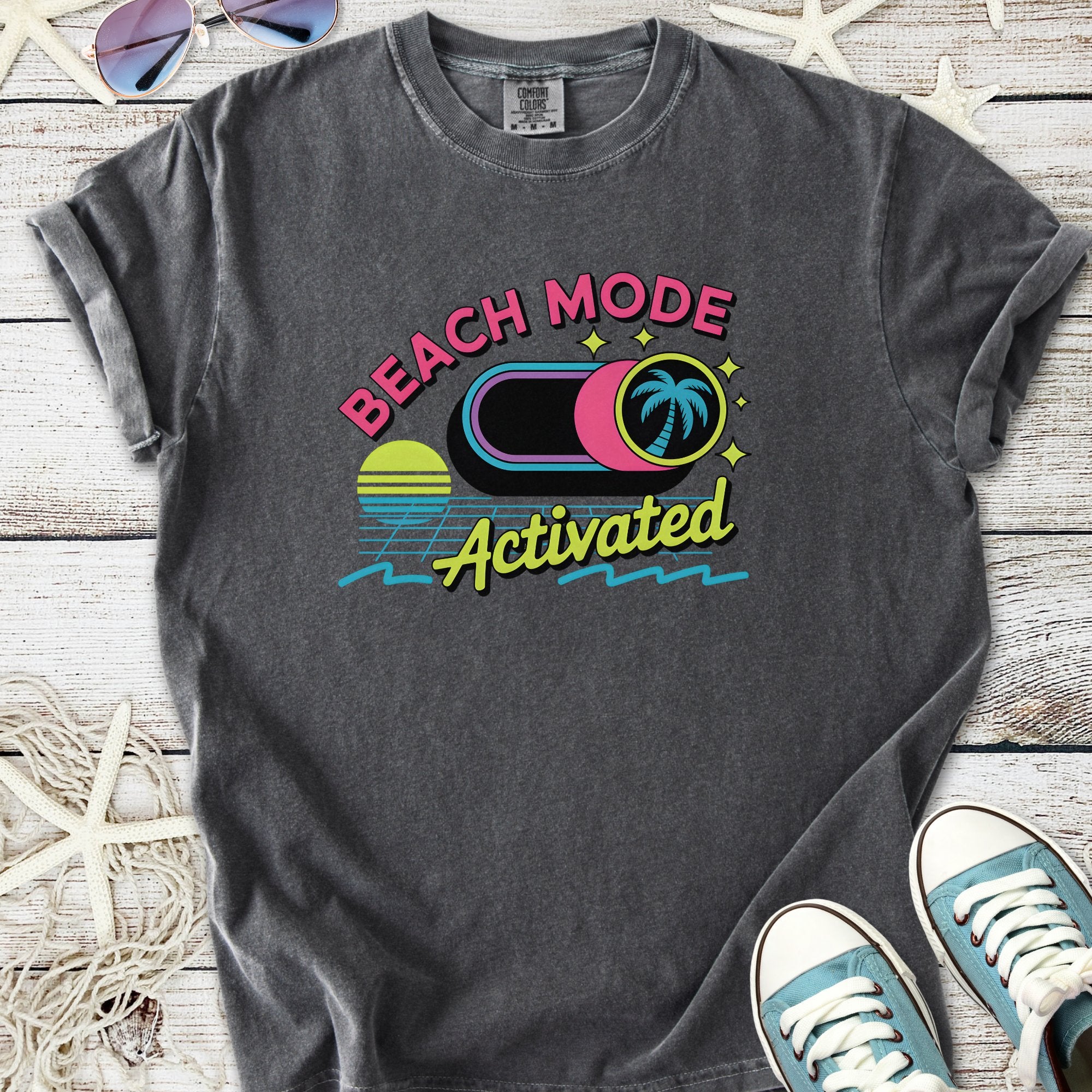 Gray graphic t-shirt featuring 'Beach Mode Activated' design with palm trees and sunset graphics.