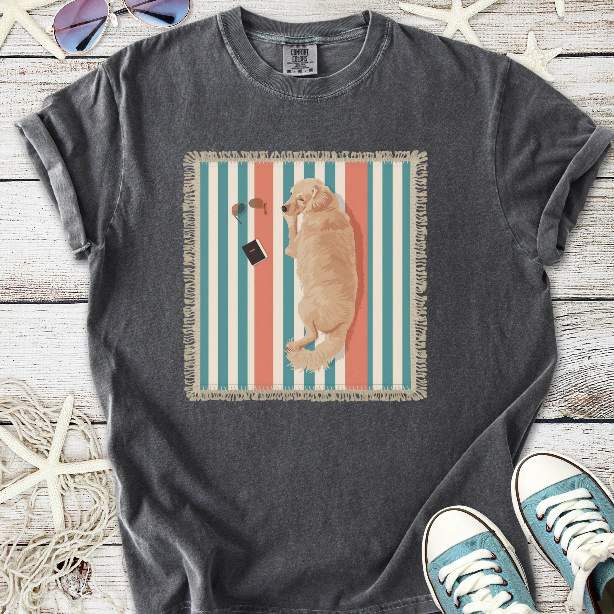 Graphic gray t-shirt featuring a golden retriever lounging on a striped blanket with sunglasses and a book.