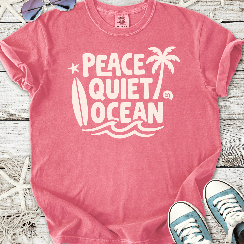 Pink graphic t-shirt featuring 'Peace Quiet Ocean' design, perfect for beach lovers and casual wear.