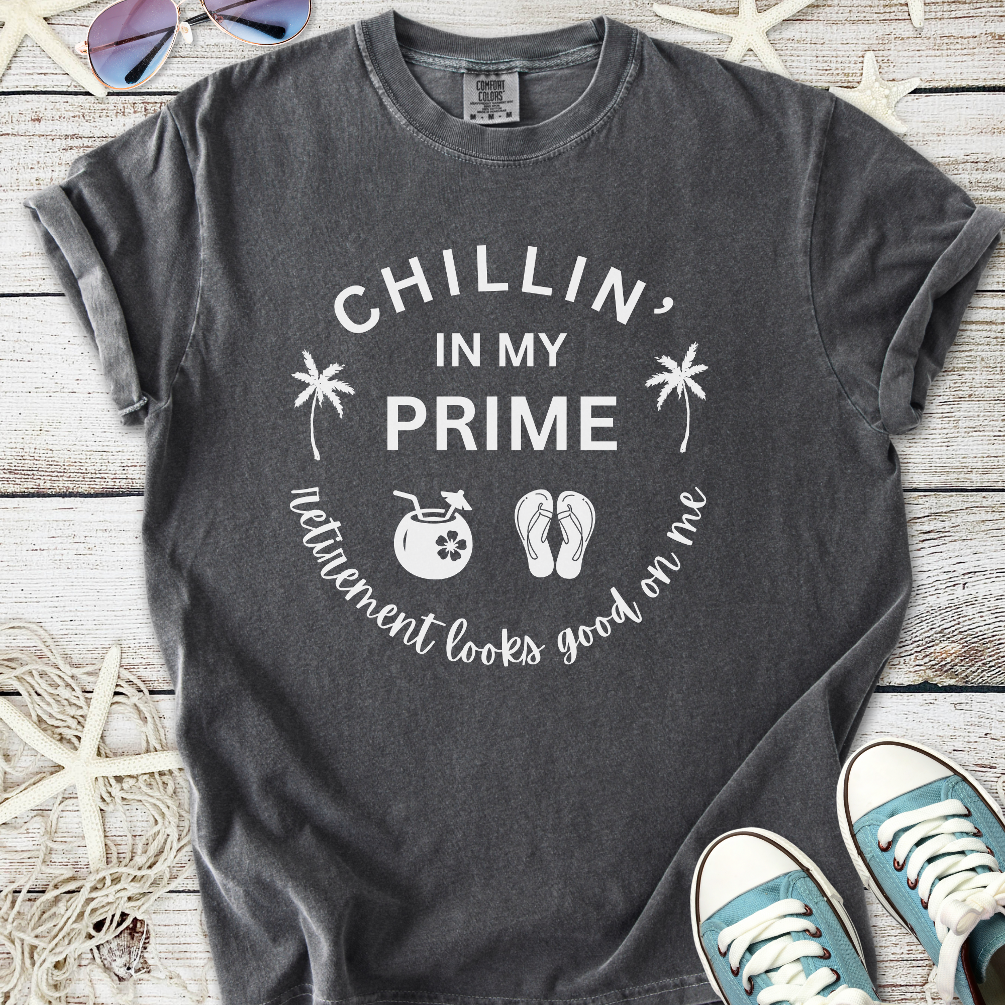 Gray t-shirt with 'Chillin' in my Prime' print, featuring palm trees and vacation icons.
