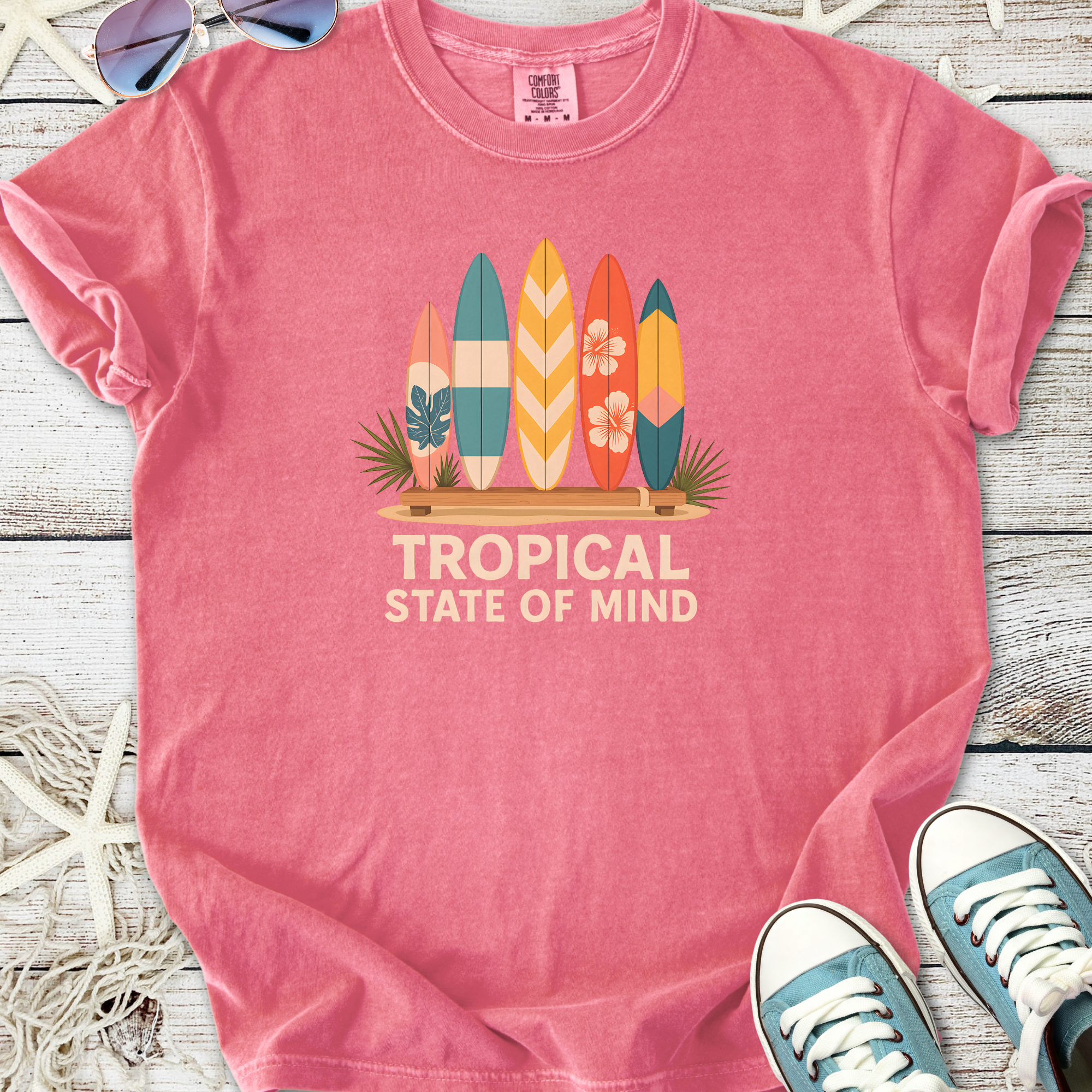 Pink t-shirt with "Tropical State of Mind" graphic and surfboards design, perfect for summer style.