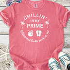 Pink graphic t-shirt with 'Chillin' in My Prime' text and fun retirement-themed icons.