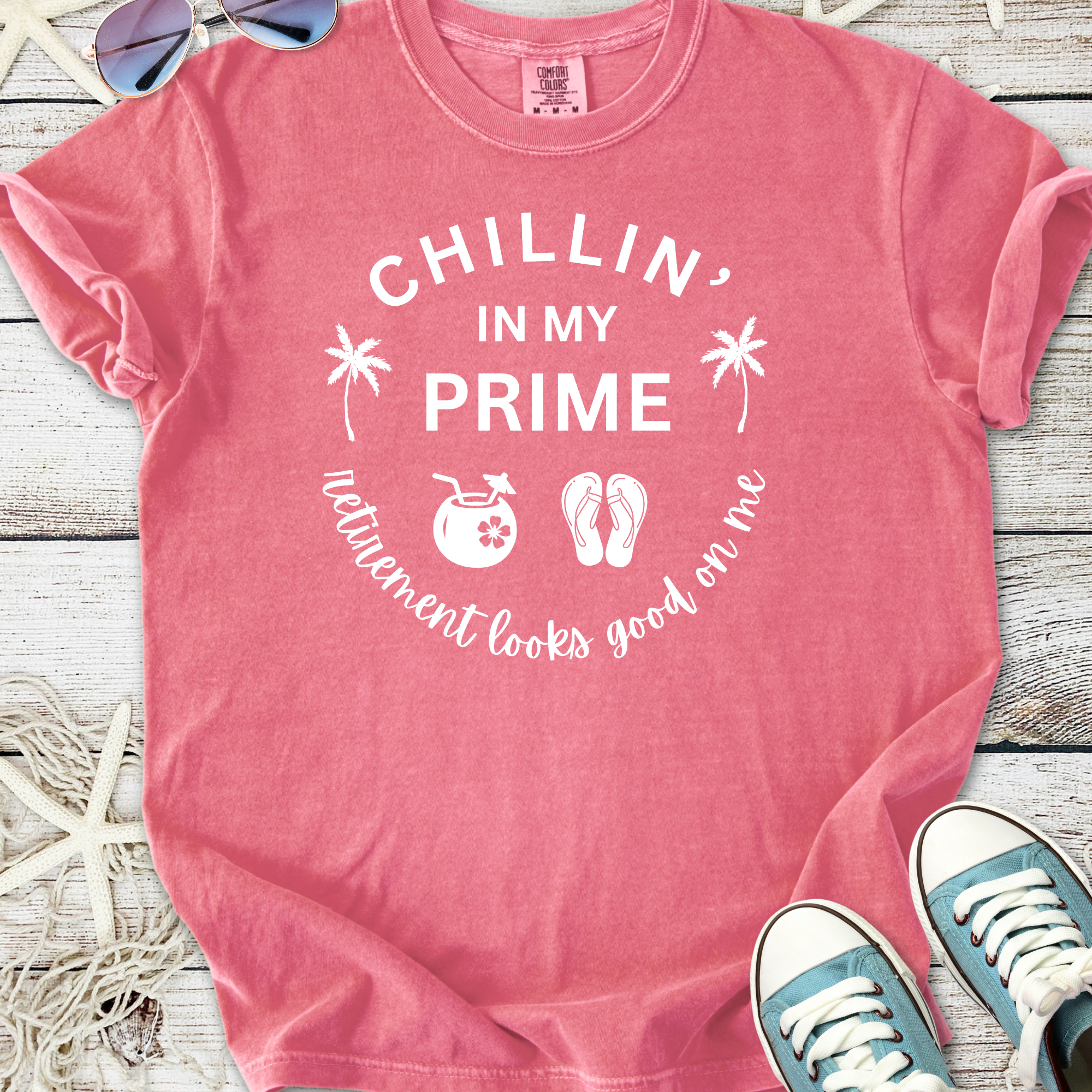 Pink graphic t-shirt with 'Chillin' in My Prime' text and fun retirement-themed icons.