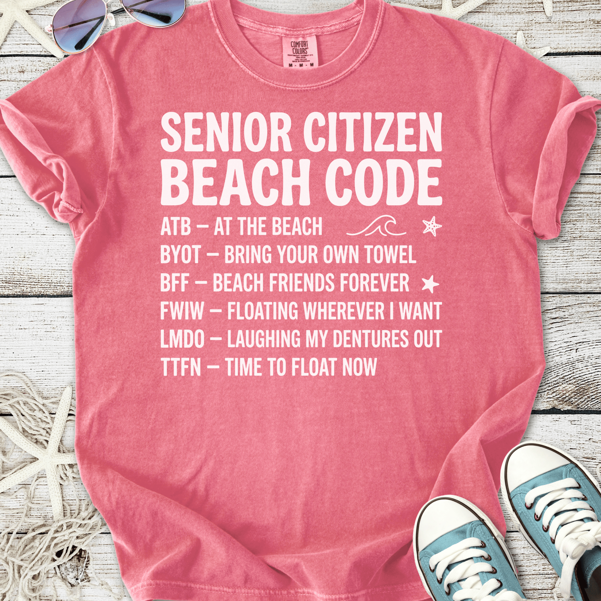 Pink cotton t-shirt featuring 'Senior Citizen Beach Code' with fun beach phrases.