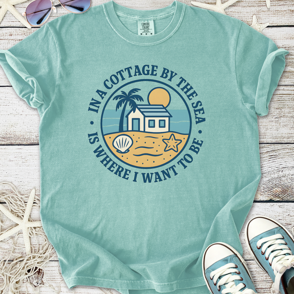 Light blue cotton graphic tee featuring beach cottage design and playful seaside elements.