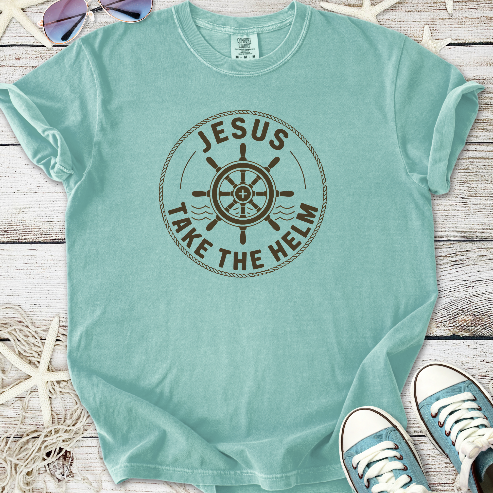 Light teal t-shirt with 'Jesus Take the Helm' graphic, made from soft cotton for comfort and style.