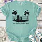 Mint green t-shirt with a dog and girl silhouette, features the phrase 'love is a four-legged word'.