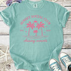 Mint green t-shirt with pink 'Sunset Social Club' graphic and palm trees, perfect for summer vibes.