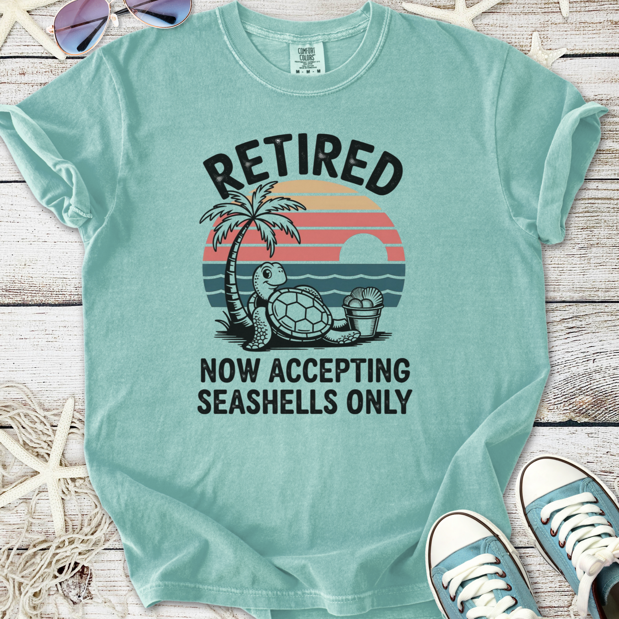 Light teal retired graphic tee featuring turtle and palm tree design, perfect for beach lovers.