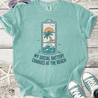 Turquoise t-shirt with beach-themed graphic saying 'My Social Battery Charges at the Beach'