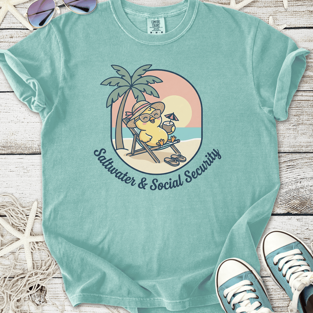 Turquoise cotton t-shirt featuring a cartoon character relaxing under palm trees with the text 'Saltwater & Social Security'.