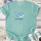 Light teal graphic tee featuring a playful whale illustration and the text 'oh whale...'