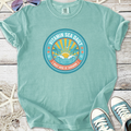 Mint green cotton t-shirt with 'Vitamin Sea Daily' graphic, perfect for beach lovers and summer vibes.