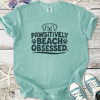 Mint green shirt with 'Pawsitively Beach Obsessed' graphic, perfect for dog lovers and beach outings.