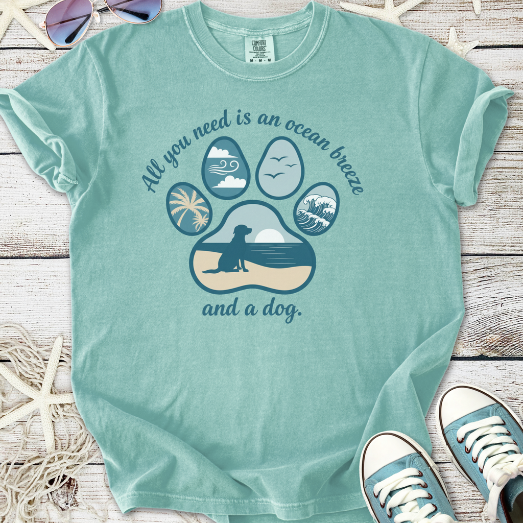 Teal graphic t-shirt featuring ocean-themed dog paw print design and motivational text.
