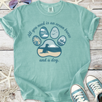 Teal graphic t-shirt featuring ocean-themed dog paw print design and motivational text.