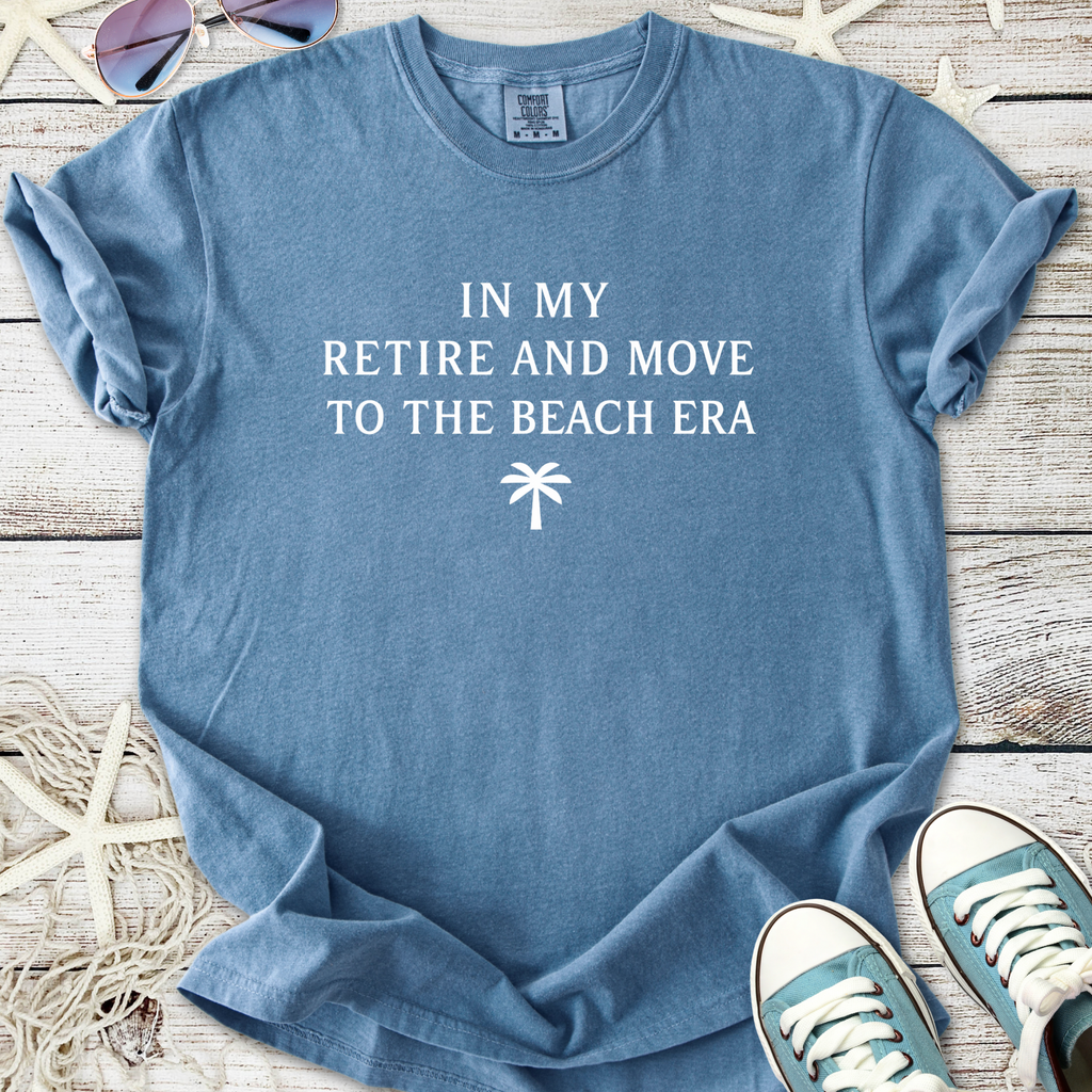 Blue cotton t-shirt with 'In My Retire and Move to the Beach Era' text and palm tree graphic.