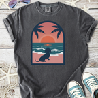 Gray graphic t-shirt featuring a dachshund by the beach at sunset, perfect for dog lovers.