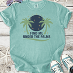 Light teal graphic tee featuring 'Find Me Under The Palms' with palm tree design and round moon.