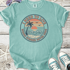 Mint green t-shirt featuring 'I Need to Live' beach graphic, perfect for summer vibes.